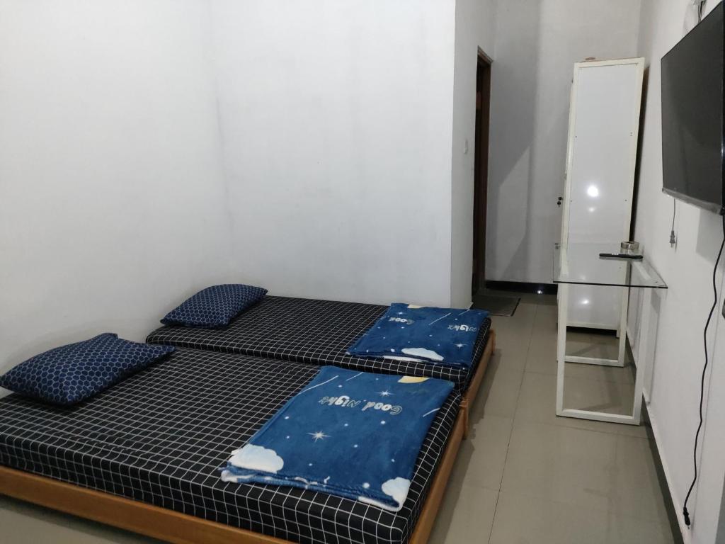 Postel nebo postele na pokoji v ubytování Hotel Residence 5 Syariah