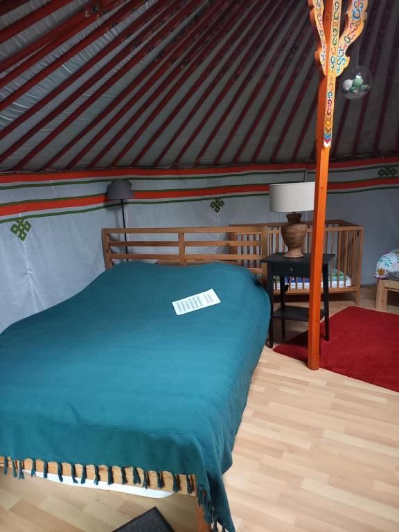a bedroom with a bed in a tent at Tiny House et yourte sous les Poiriers in Domfront