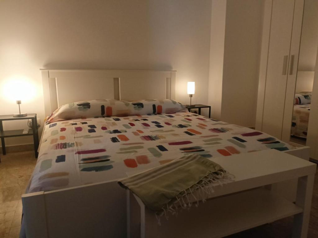a bedroom with a large bed with a colorful bedspread at Alla marina in Fiumefreddo di Sicilia