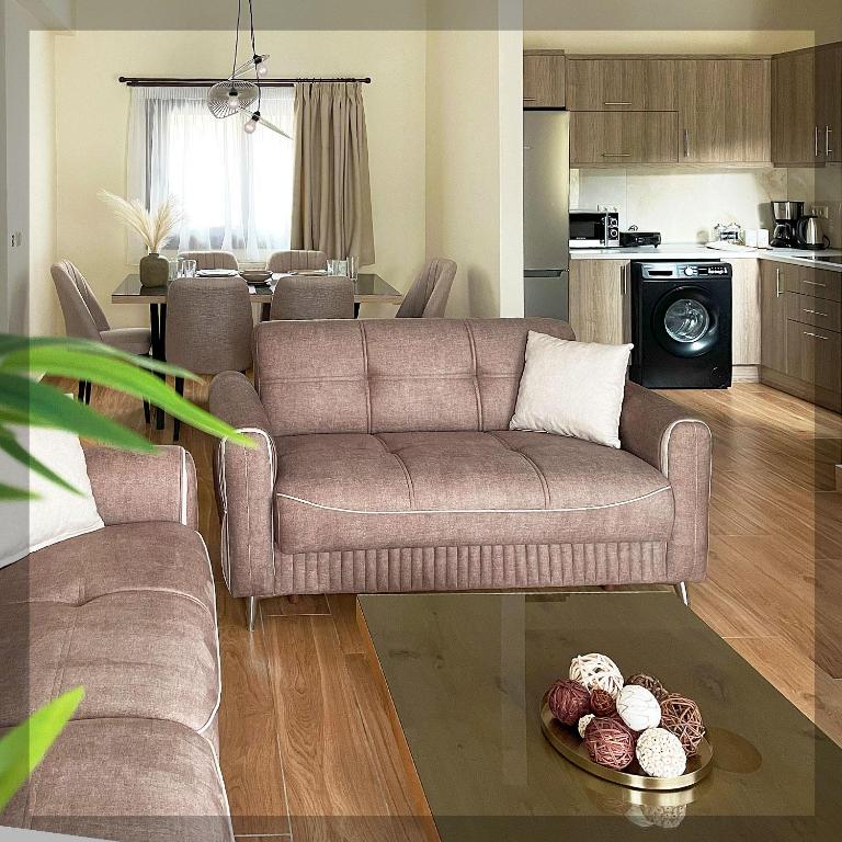 a living room with a couch and a table at Favelas Luxury Apartments in Kavála