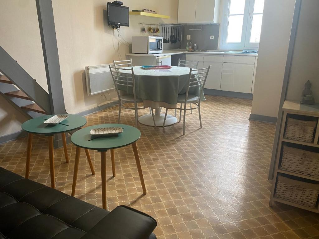 a room with a table and chairs and a kitchen at Studio Remblai LS in Les Sables-d'Olonne