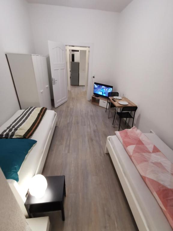 a room with a bed and a desk and a television at Modern Apartment Hagen - Dortmund in Hagen