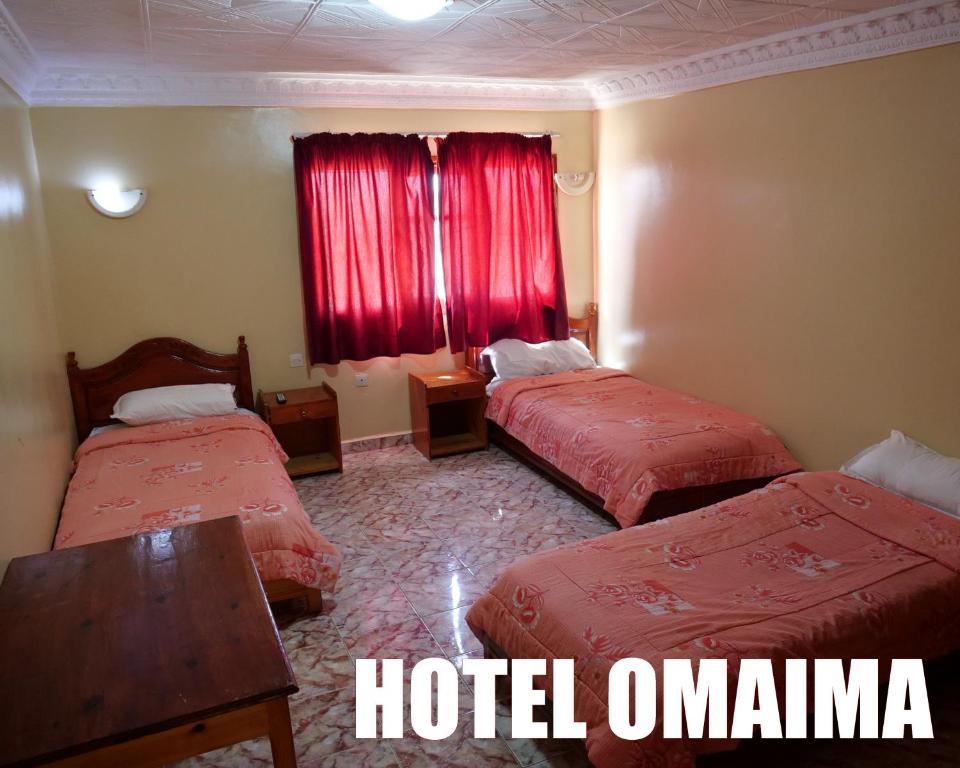 Letto o letti in una camera di Hotel OMAIMA