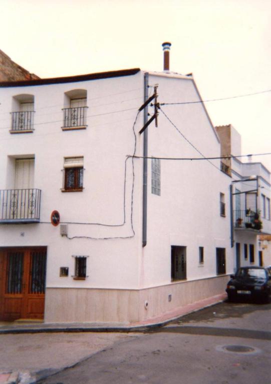 a large white building with a car parked next to it at Casa De Maestro, costa Dorada in Alcanar