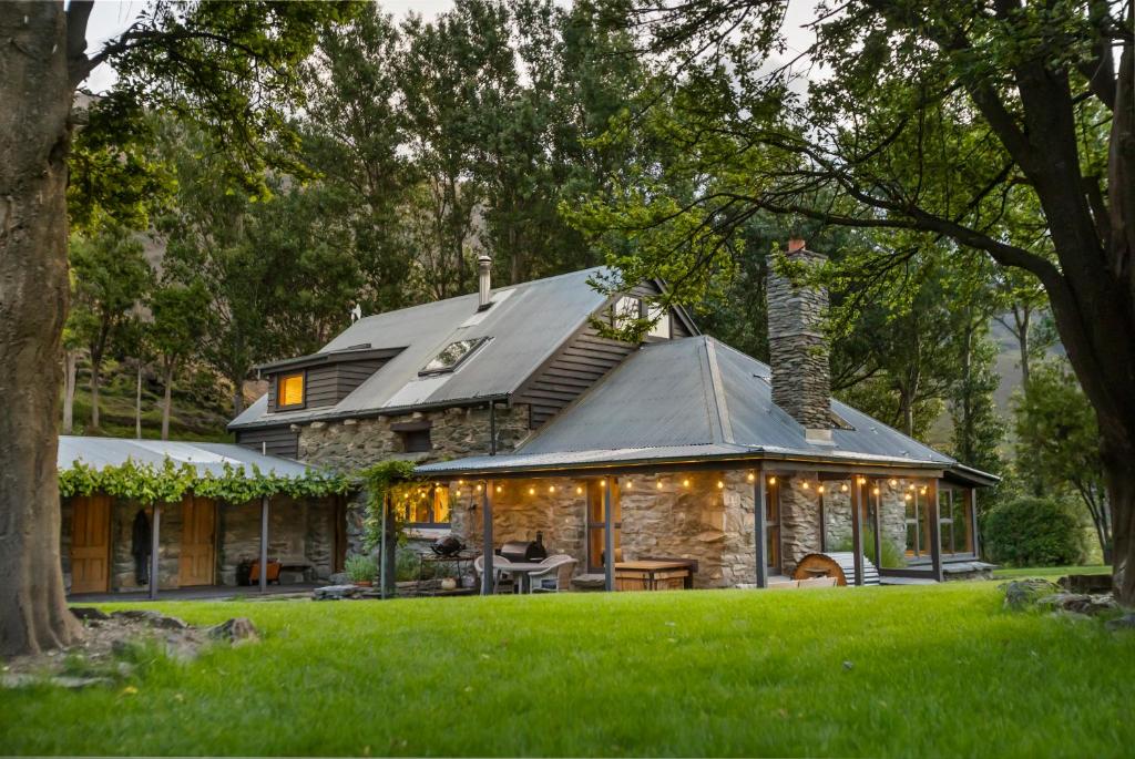 a stone house with a gambrel roof at Judge & Jury Farm Retreat in Gibbston