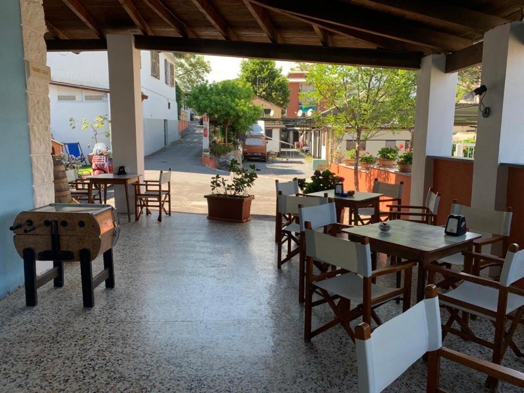 an outdoor patio with tables and chairs and a table at Parco vacanze e appartamenti Pfirsich in Borghetto Santo Spirito