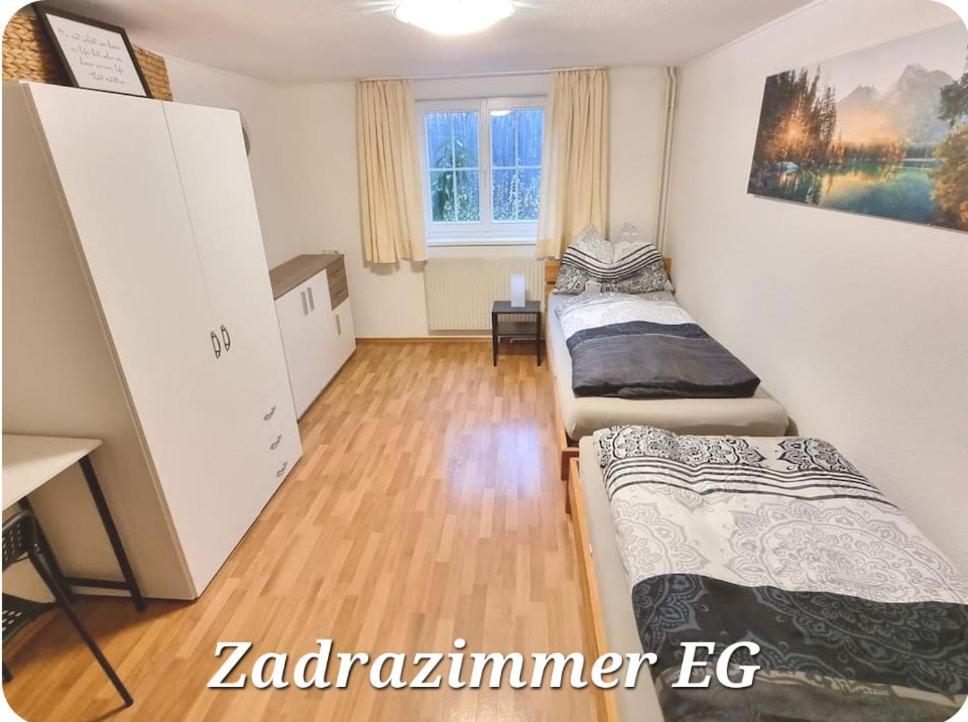 a room with two beds and a desk in it at ZADRA Home in Dornbirn