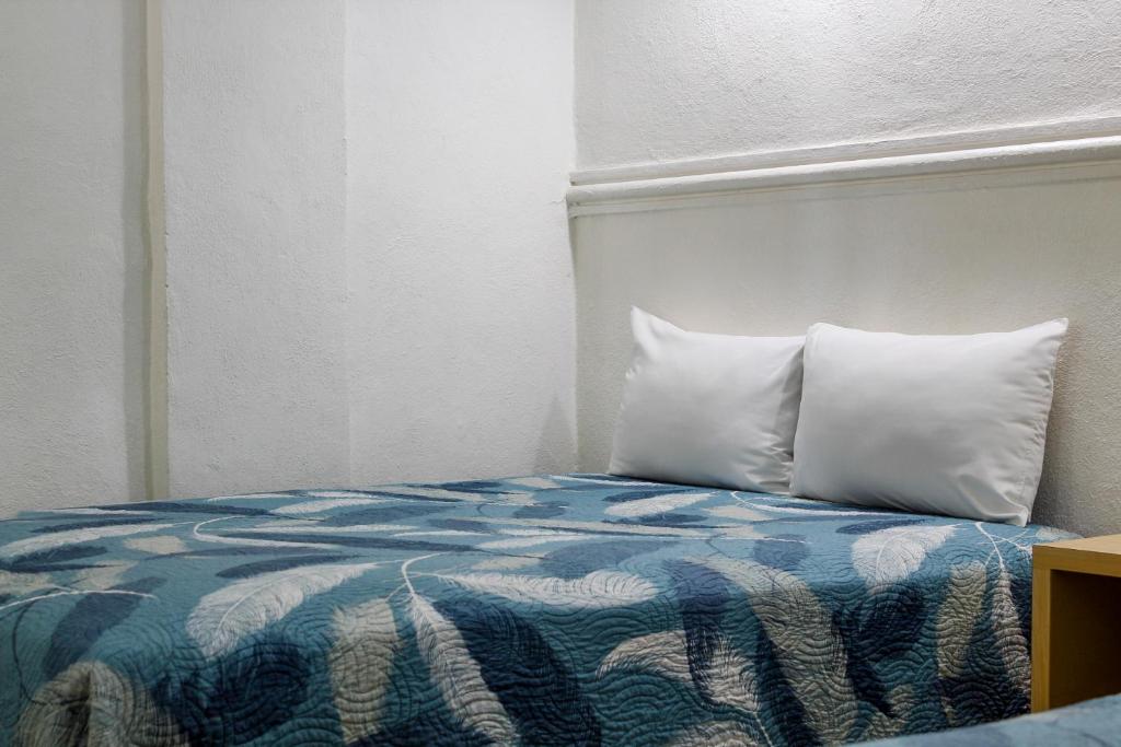 Postel nebo postele na pokoji v ubytování Hotel Nueva Zelanda