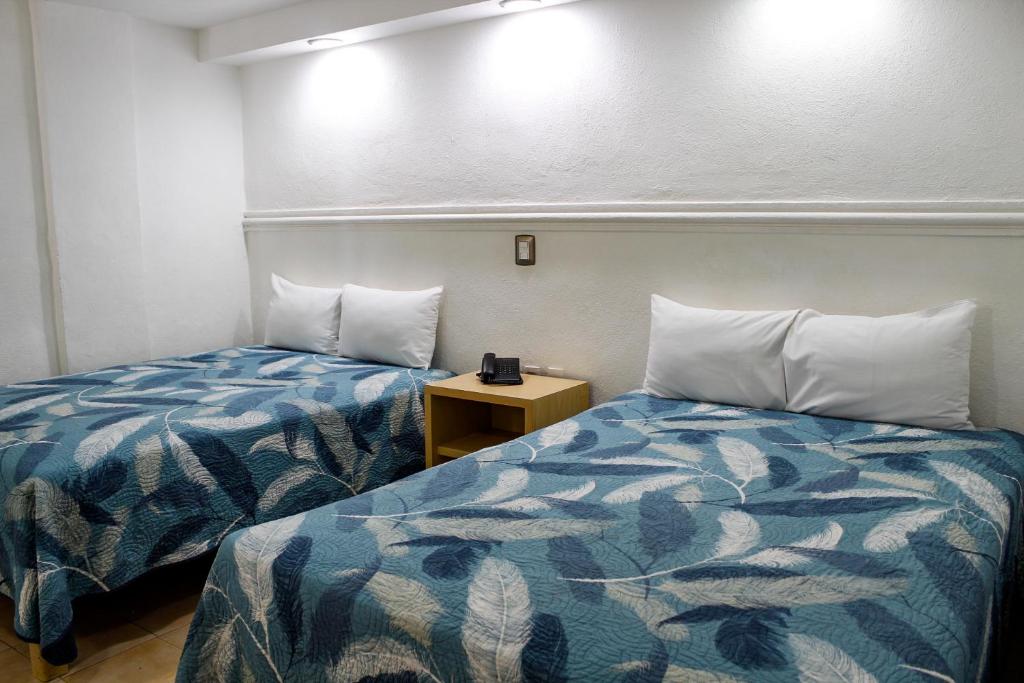 Postel nebo postele na pokoji v ubytování Hotel Nueva Zelanda
