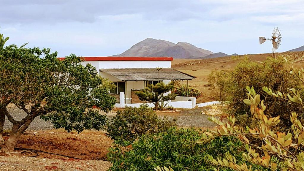 uma casa no meio de um campo com montanhas em Casa-Molino em Tuineje