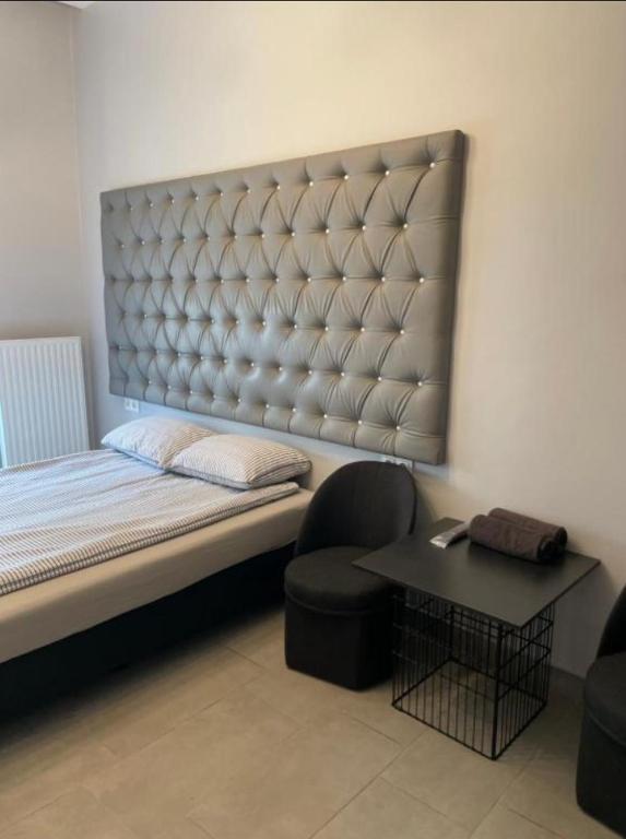 a bedroom with a bed and a chair and a table at Rooms Spanie 7-Rynek Centrum &f-vat in Kielce
