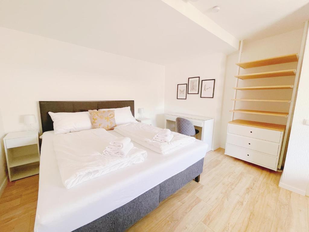 a bedroom with a large white bed and a closet at StayHere Central City Studio 14 - contactless Self-Check-IN in Graz