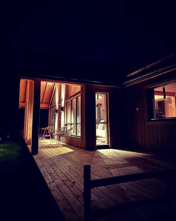 a dark room with a porch with windows and a chair at Snowcake Cottage in Sør-Fron
