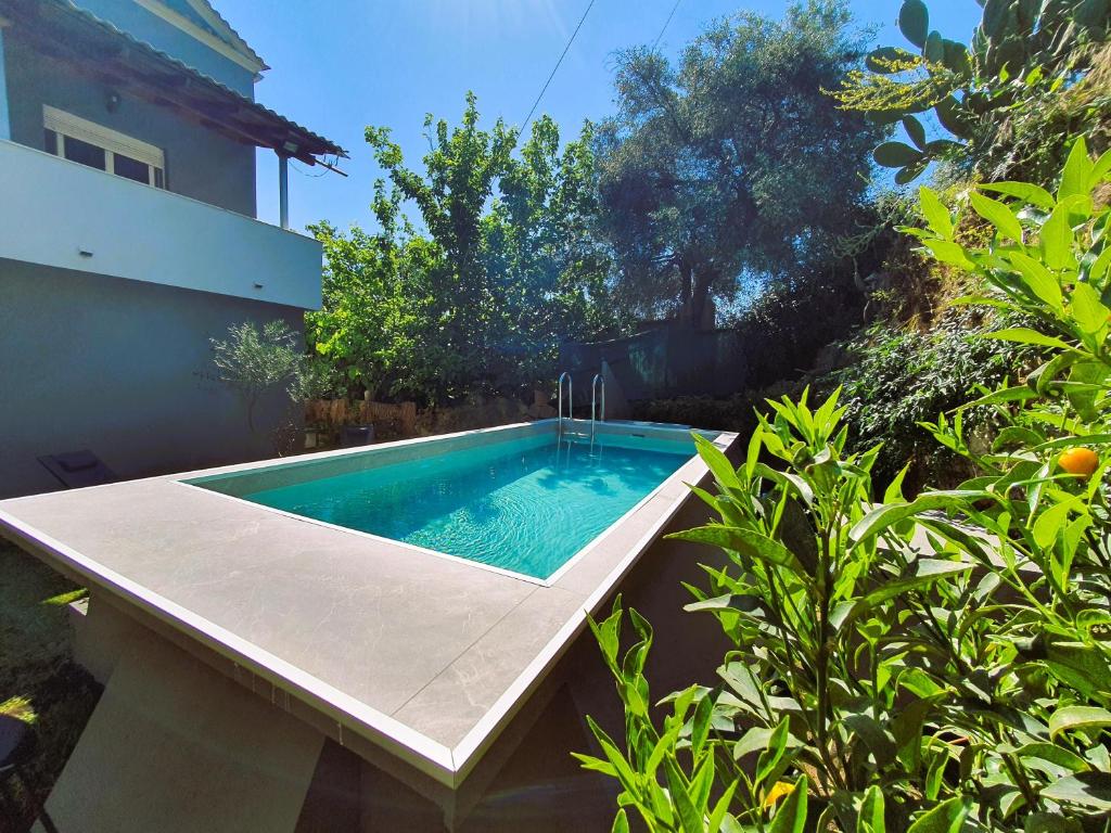 a swimming pool in the backyard of a house at Faeax Guesthouse in Línia