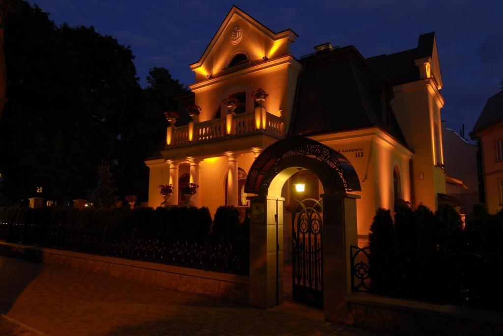 a building with a gate in front of it at night at Luxury Boutique Andreevskiy in Lviv