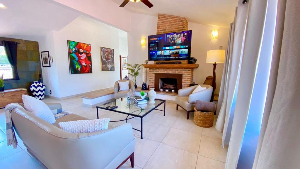 a living room with white furniture and a fireplace at Ajijic San Antonio Lake Chapala Villas - Pickleball Court - Gym in San Antonio