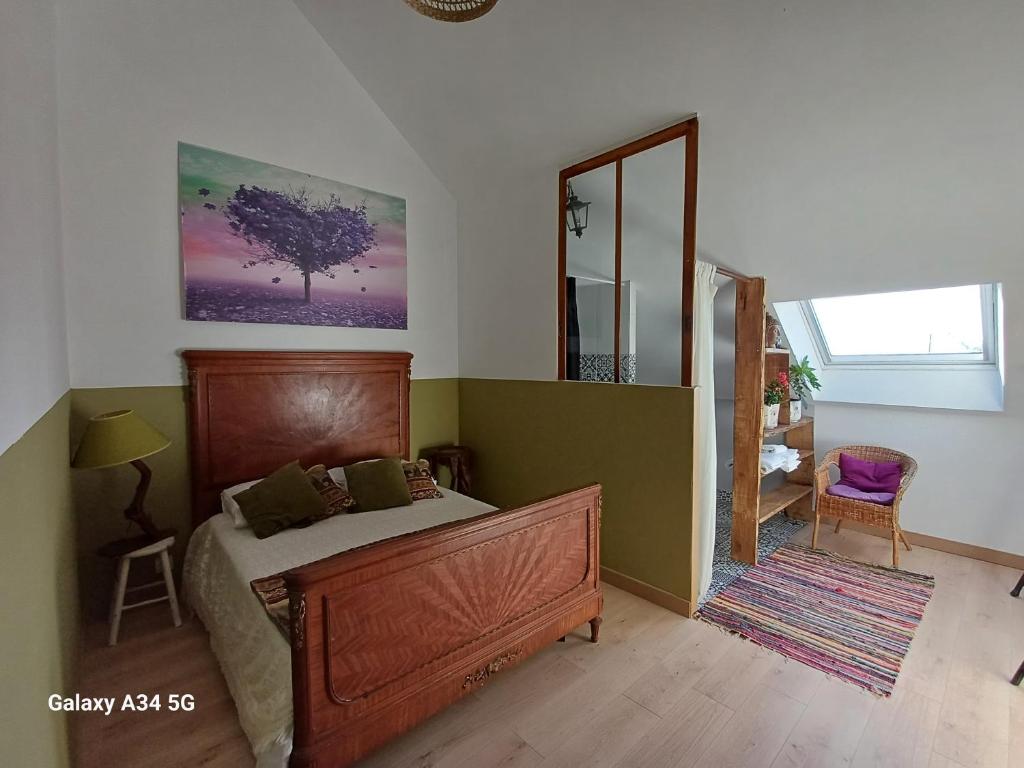 une chambre avec un lit et un grand miroir dans l'établissement Les Chaumes Violettes, à Cluis