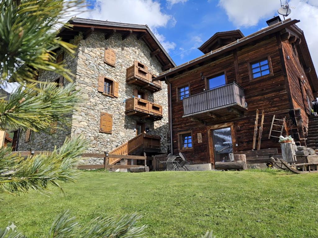 a large log building with a balcony on it at Chalet Pizabela Bait da Pizabela in Livigno