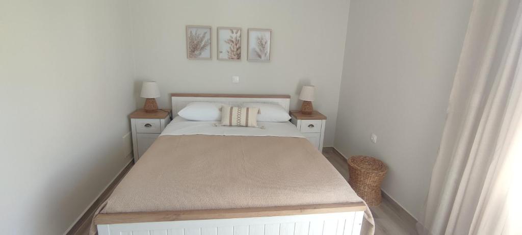a small bedroom with a bed and two night stands at Casa di Calma in Ermoupoli