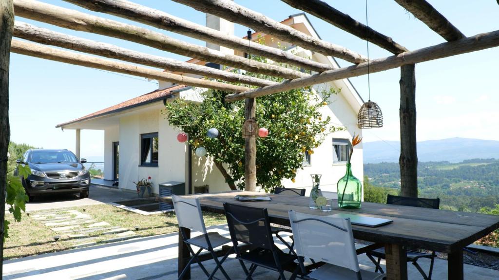a table and chairs on the patio of a house at Quinta da Luena in Candemil