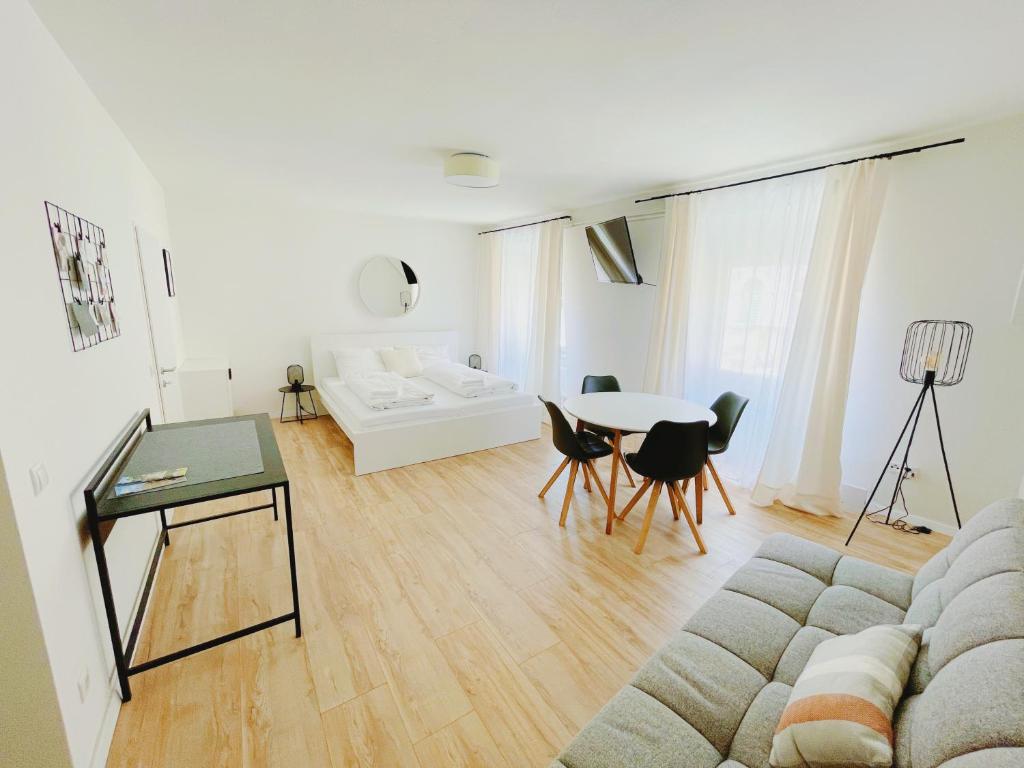 een woonkamer met een bank en een tafel bij StayHere Central City Studio 12 - contactless Self-Check-IN in Graz
