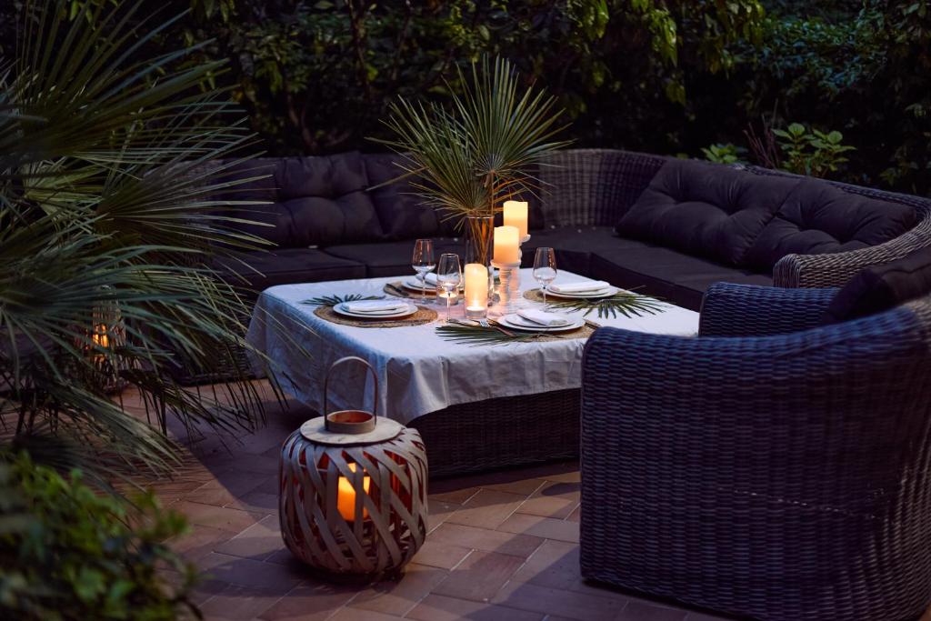 a patio with a table with candles and a couch at GREEN HILL Aparts with POOL & SCENIC VIEW in Gornji Orahovac