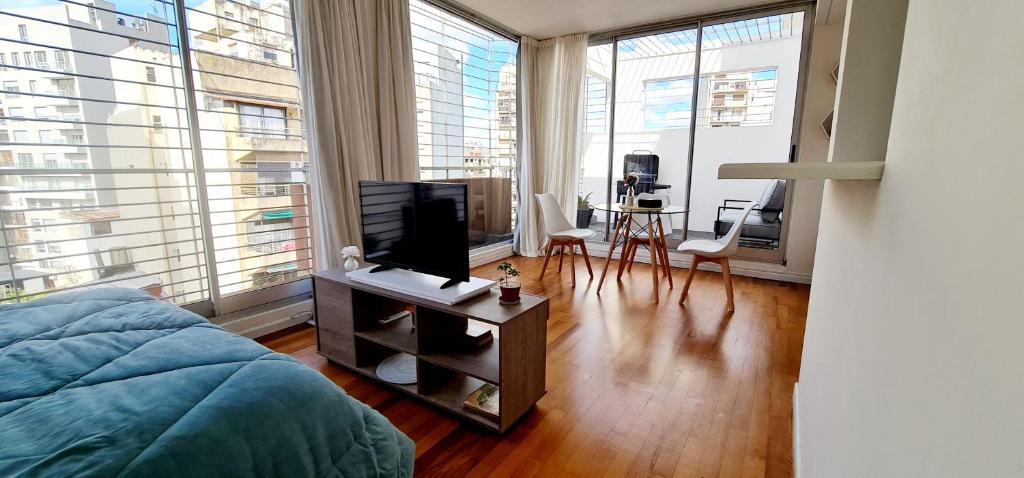 1 dormitorio con 1 cama y TV en una mesa en Cozy studio in Recoleta en Buenos Aires