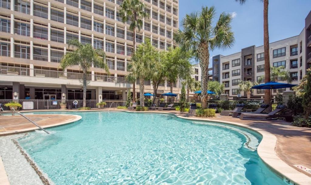 a large swimming pool in front of a building at Houston Getaway in Houston