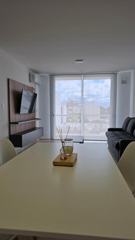 a living room with a table and a couch at Alquiler temporario AC 10 in Arroyito
