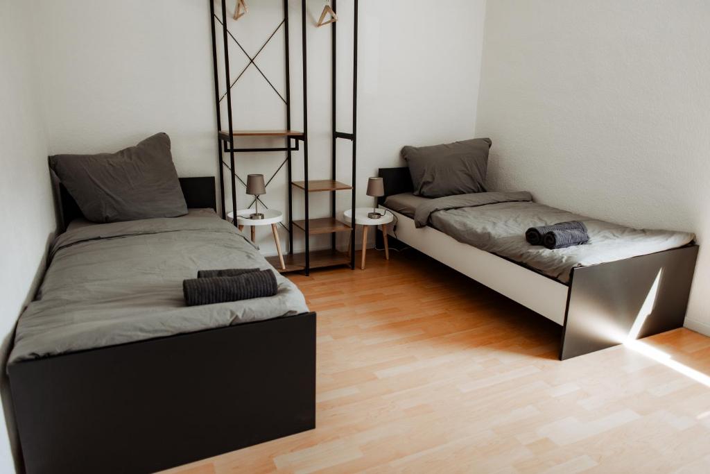 a room with two beds and a wooden floor at 5 Bett-Wohnung in guter Lage von Geilenkirchen in Geilenkirchen