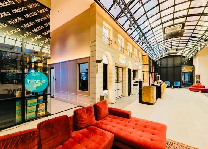 a lobby with a red couch in a store at Scarletz Suites KLCC by M Suites in Kuala Lumpur