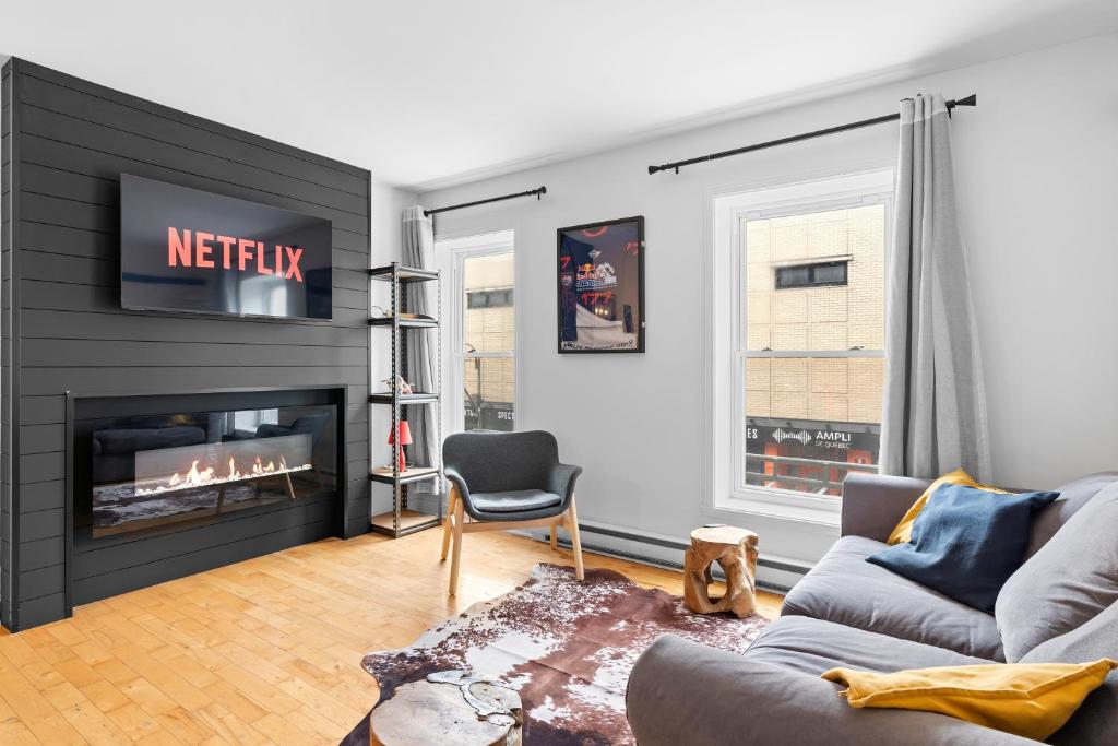 a living room with a couch and a fireplace at The redbull lodge with parking in Quebec City