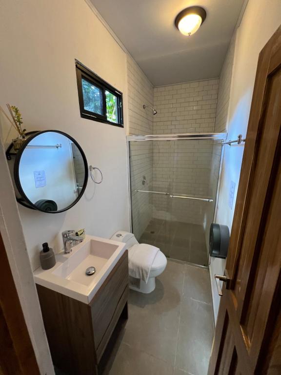 a bathroom with a sink and a toilet and a mirror at Nativo in Santa Catalina