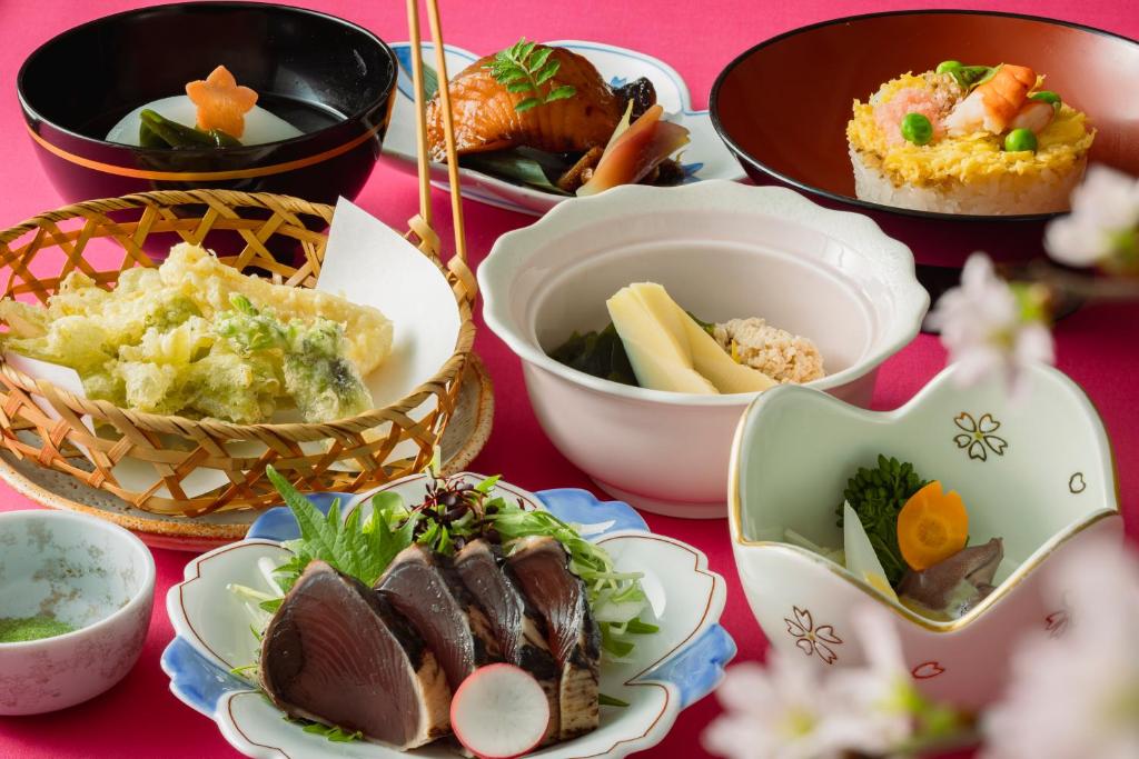 a table topped with plates of food and bowls of food at Rihga Royal Hotel Hiroshima in Hiroshima
