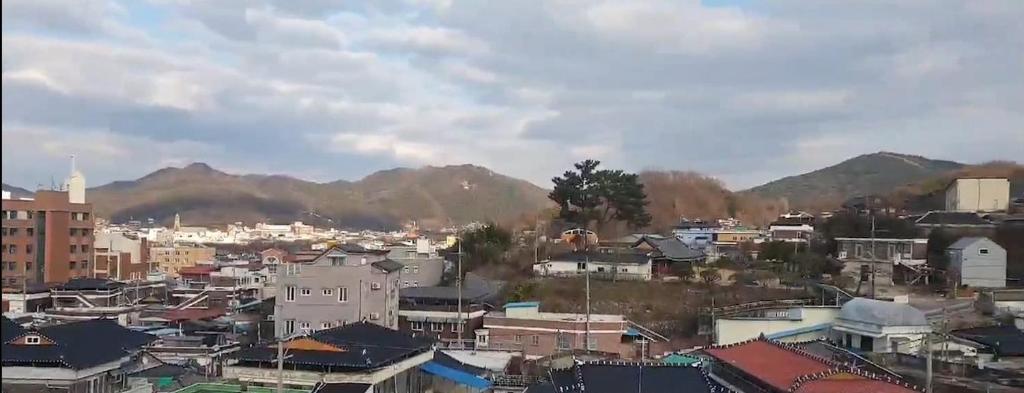 a view of a city with mountains in the background at 더드림하우스 in Jeonju