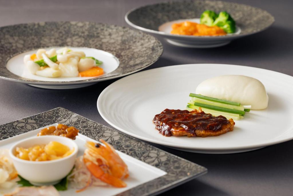 a group of plates of food on a table at Rihga Royal Hotel Hiroshima in Hiroshima