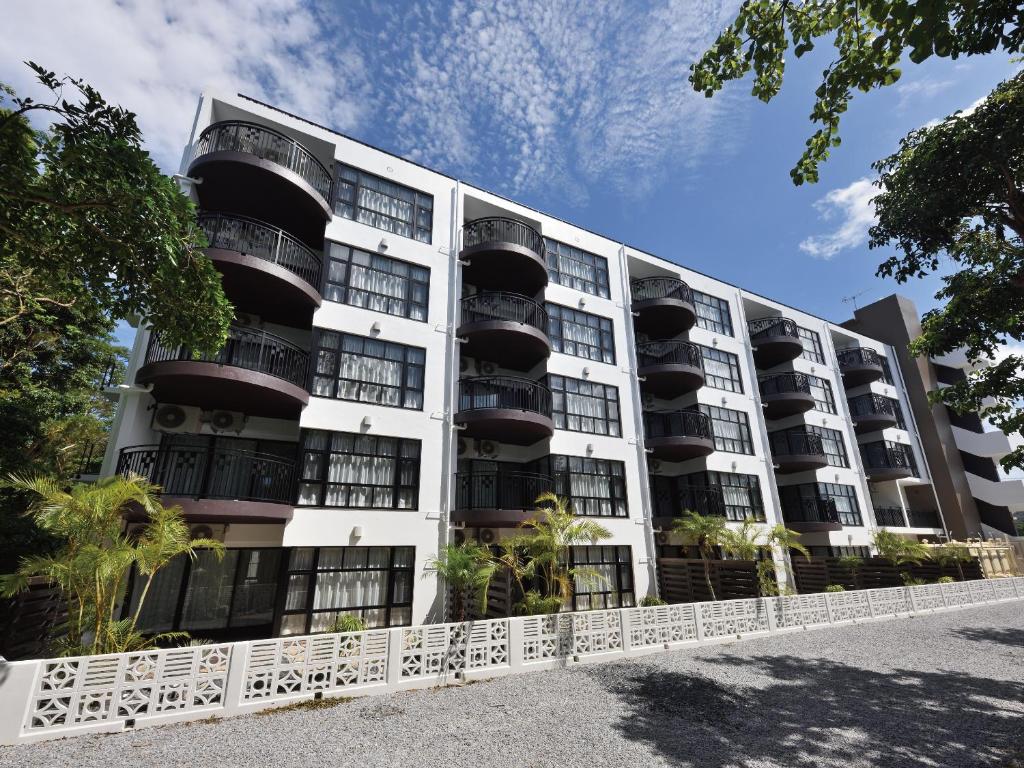 an apartment building with balconies on the side at Karry CONDO CHURAUMI in Motobu