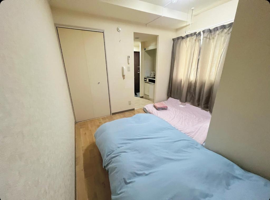 Postel nebo postele na pokoji v ubytování MATUBARA HOUSE