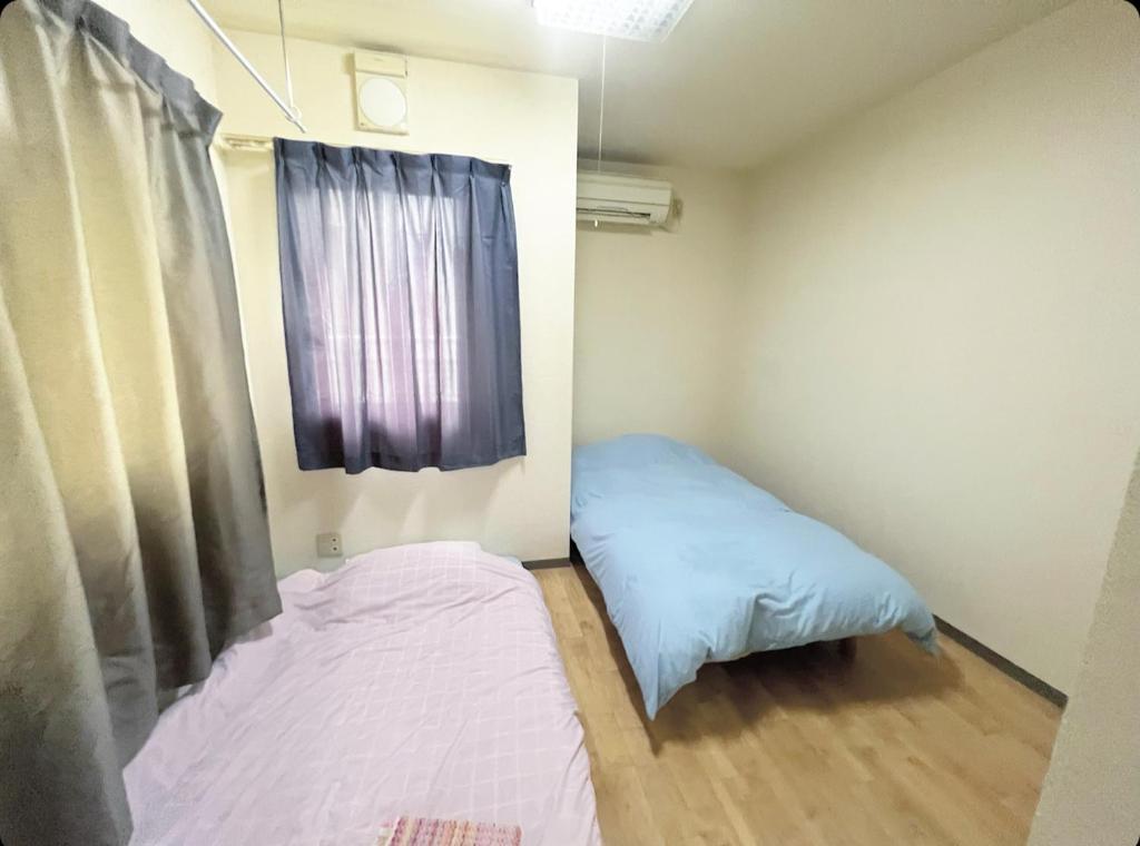 Postel nebo postele na pokoji v ubytování MATUBARA HOUSE
