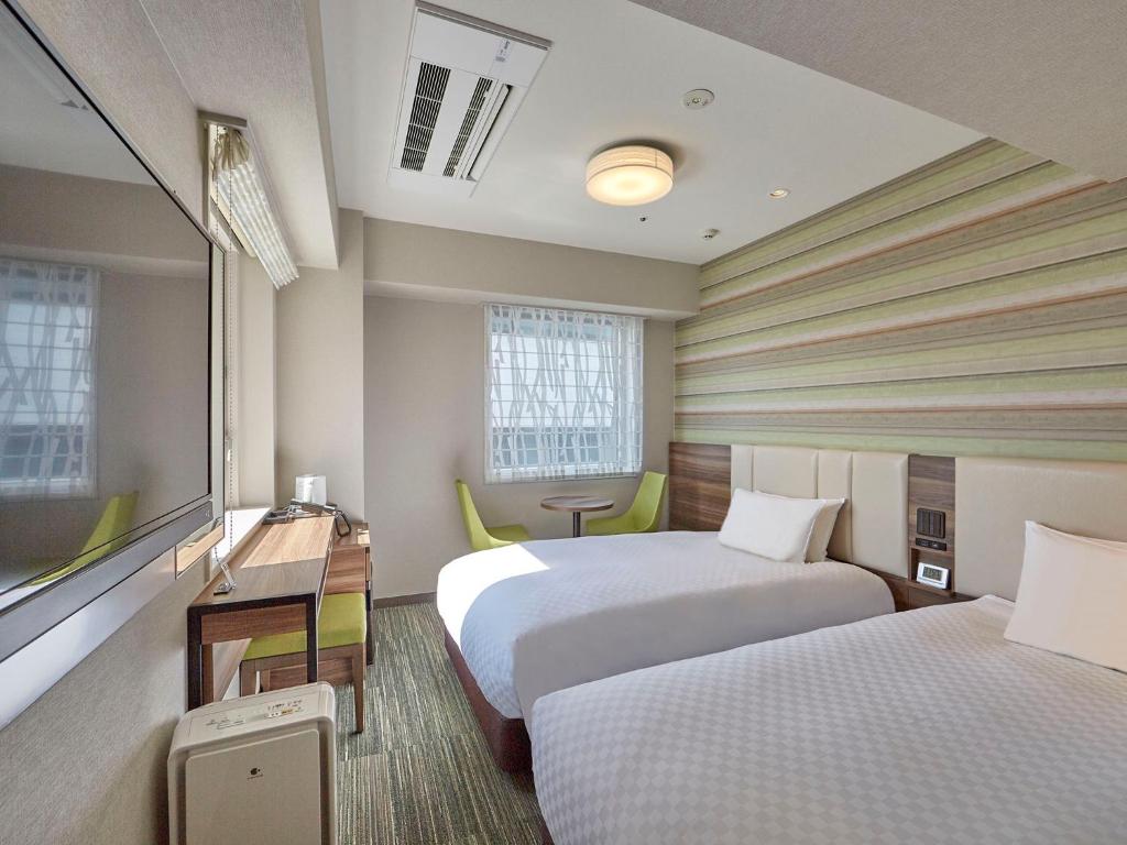 Postel nebo postele na pokoji v ubytování Hearton Hotel Shinsaibashi Nagahoridouri