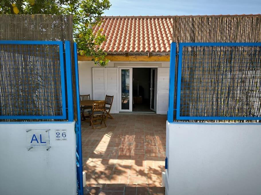 an open gate to a house with a patio at 26 Casa dos Miúdos - Alfarim in Sesimbra