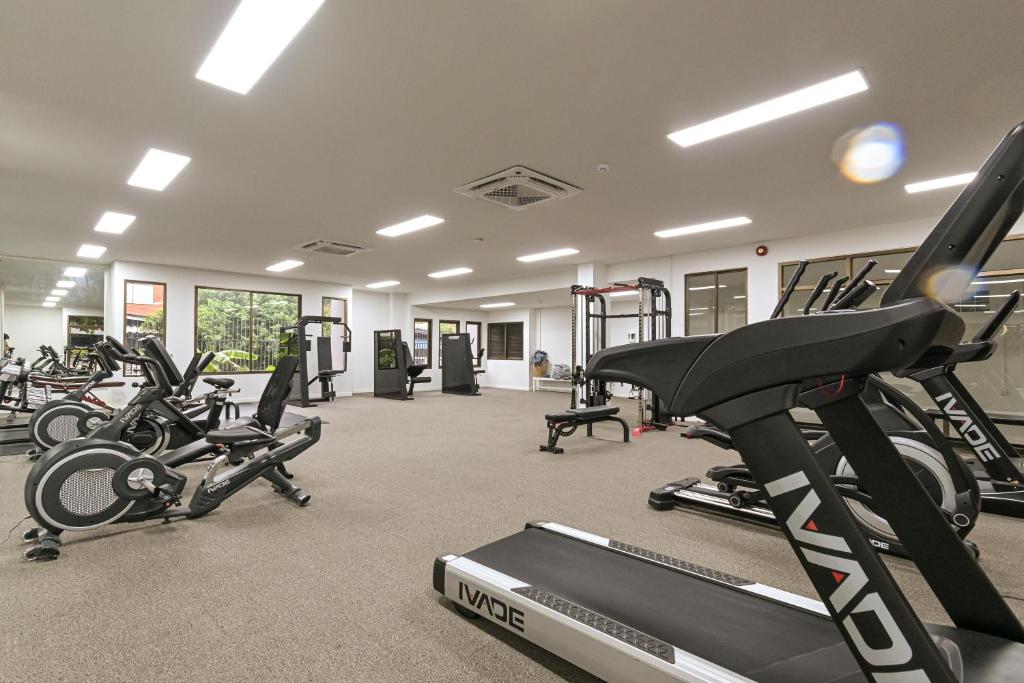 A spacious fitness room with treadmills, exercise bikes and weight machines.