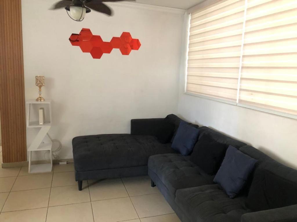 a living room with a couch and a window at Mistic hills in Panama City