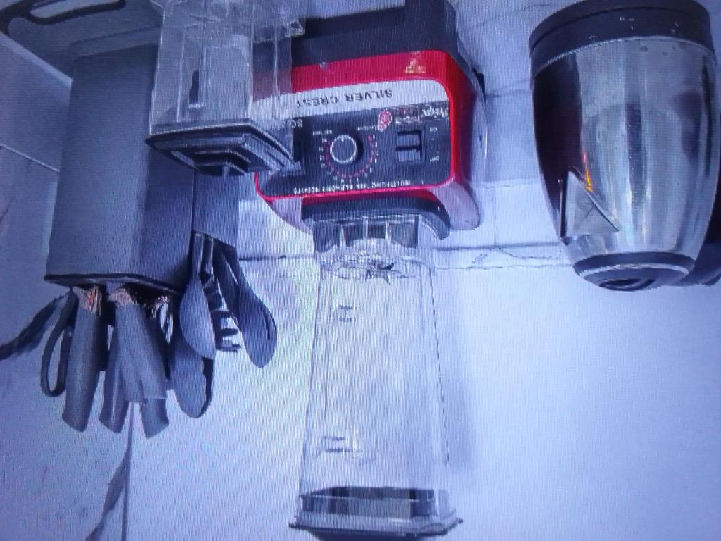 um misturador de kitchenaid pendurado numa parede com utensílios em Light house hotel and apartments Lekki phase 1 em Lekki
