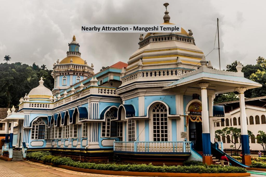 a blue and white building with turrets at OYO Venkatesh Leela Hotel in Goa