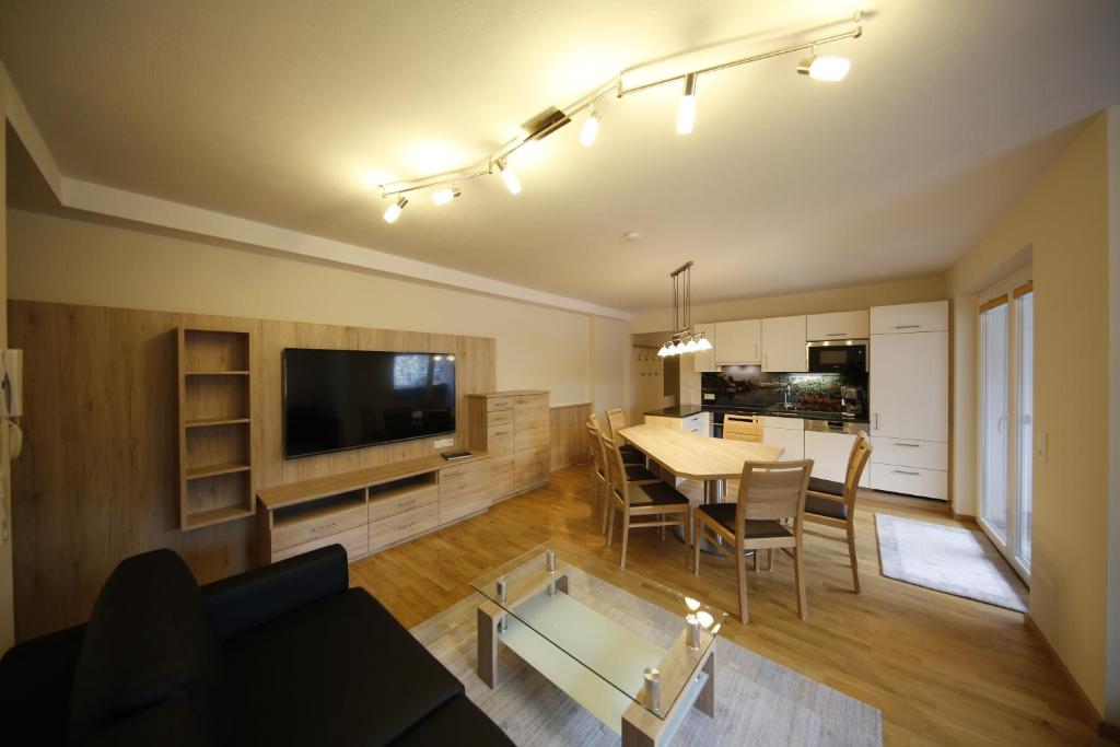 a living room with a table and a dining room at Appartement Central by Schladmingurlaub in Schladming