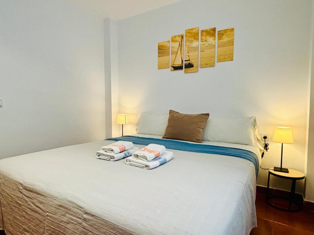 A bed or beds in a room at Apartamentos Plus Costa Brava Pals