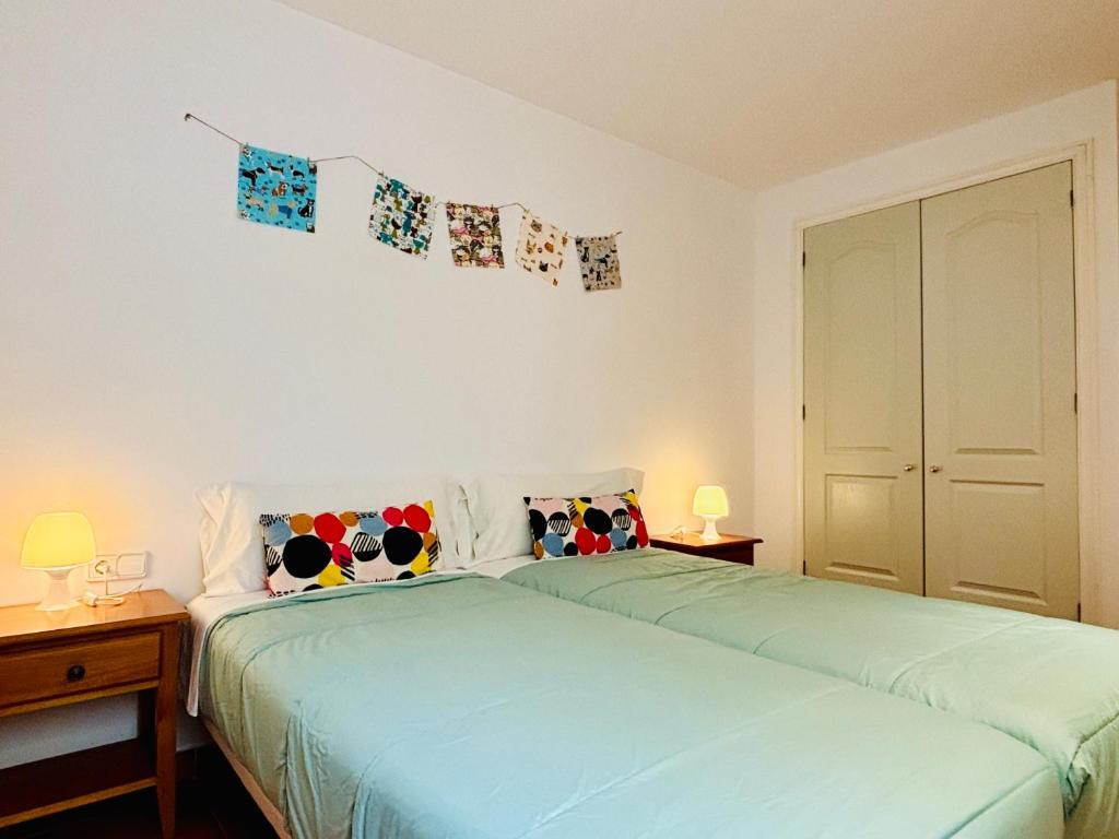 A bed or beds in a room at Apartamentos Plus Costa Brava Pals