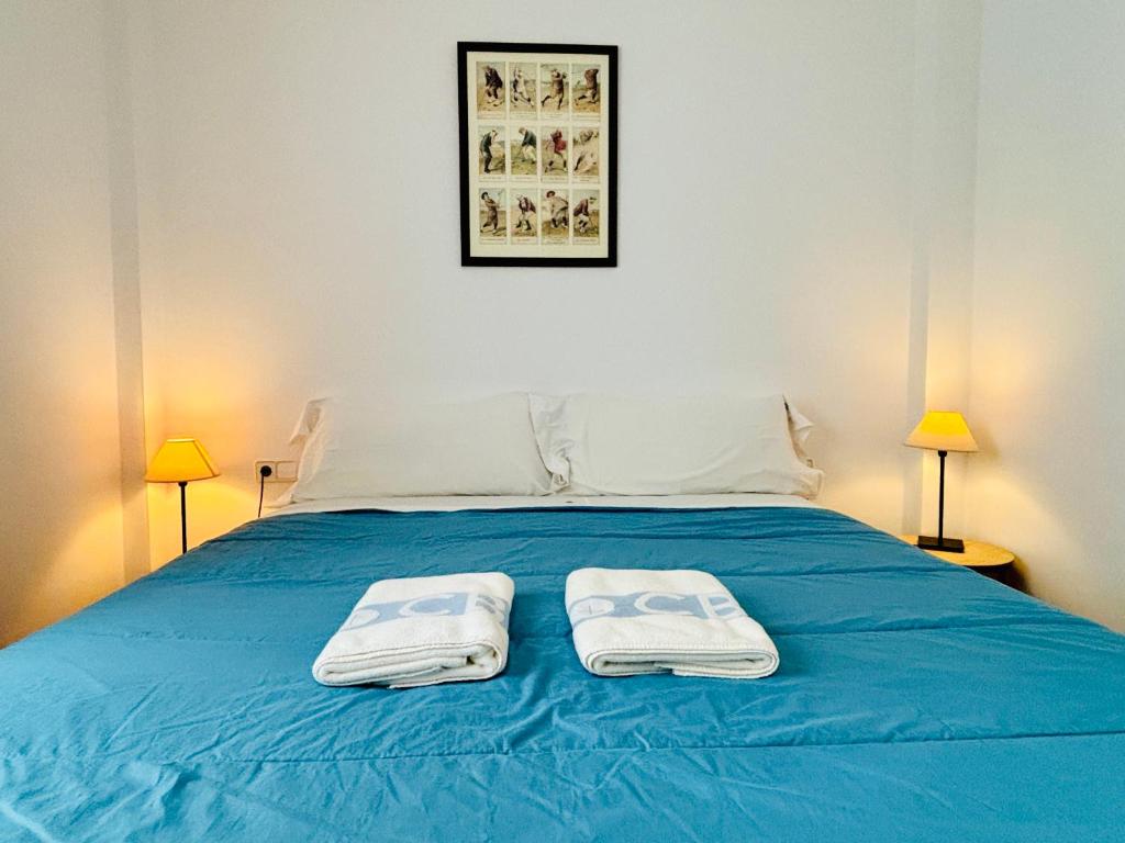 A bed or beds in a room at Apartamentos Plus Costa Brava Pals