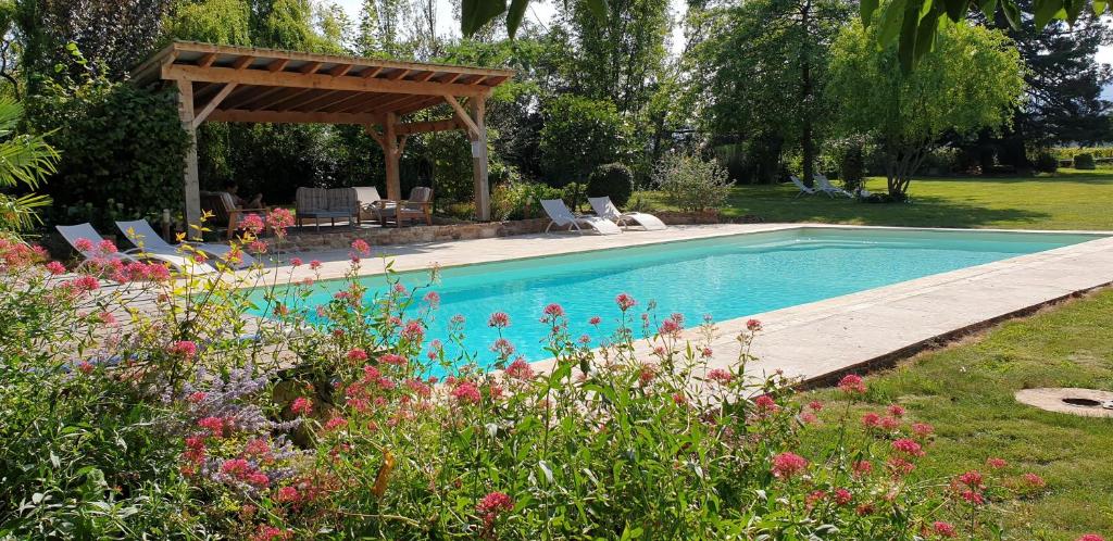 a swimming pool with a gazebo in a garden at Château de Grandmont - Escale authentique au coeur des vignes in Blacé